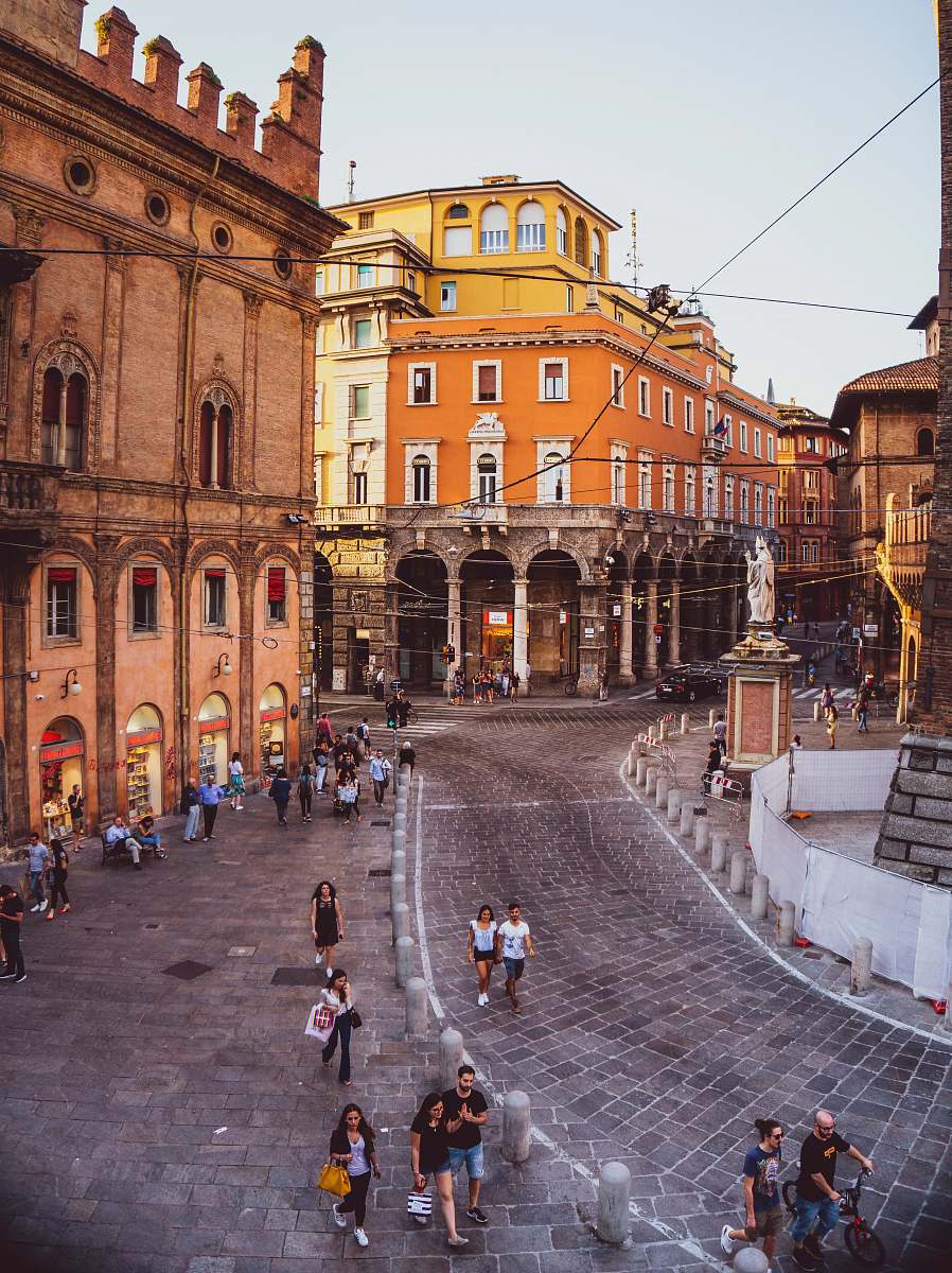 path people walking on road beside building walkway