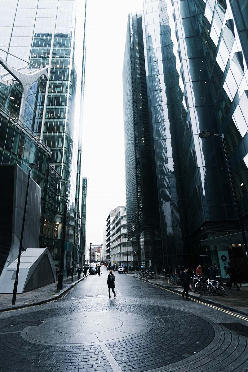 city person standing on road near building architecture