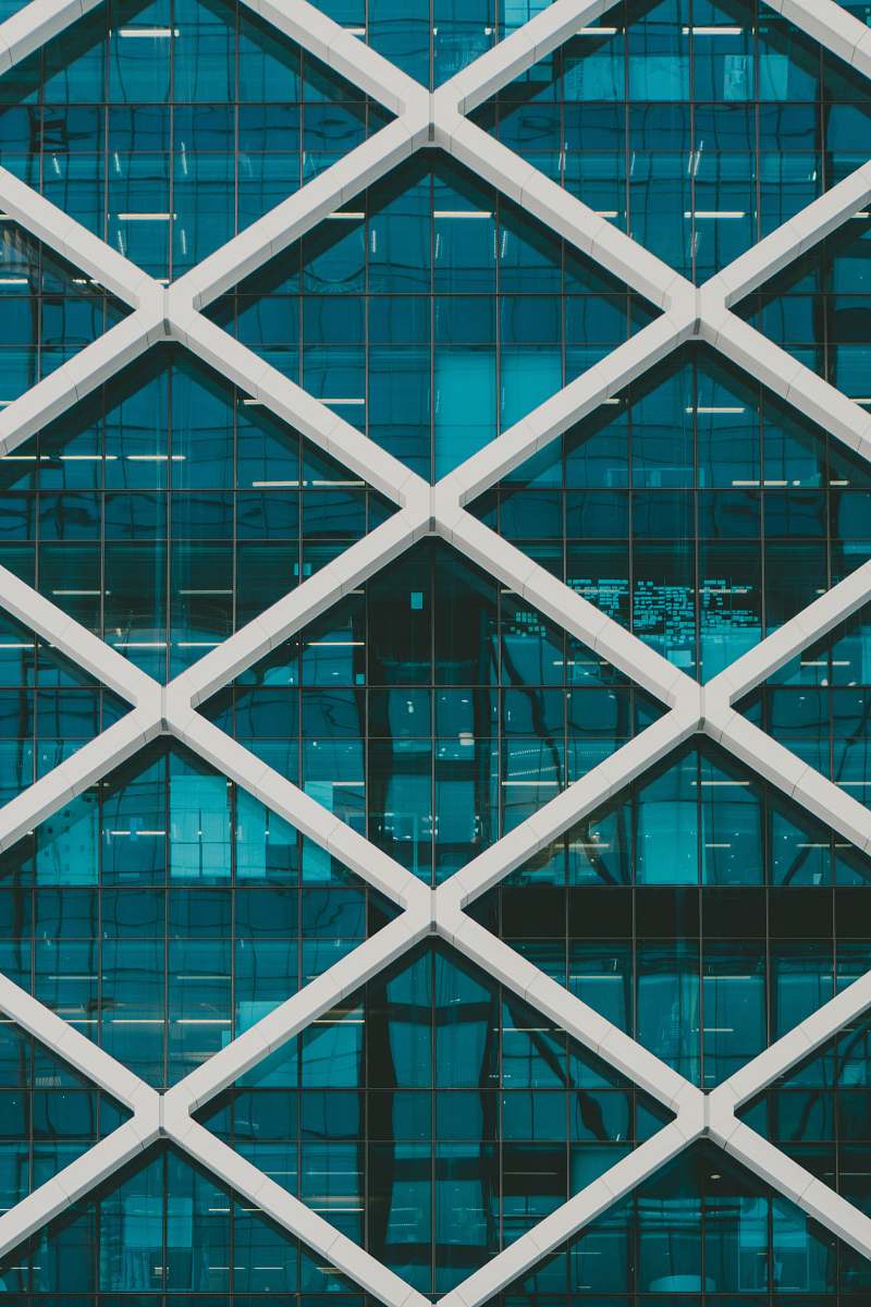 architecture teal and white high-rise building at daytime window