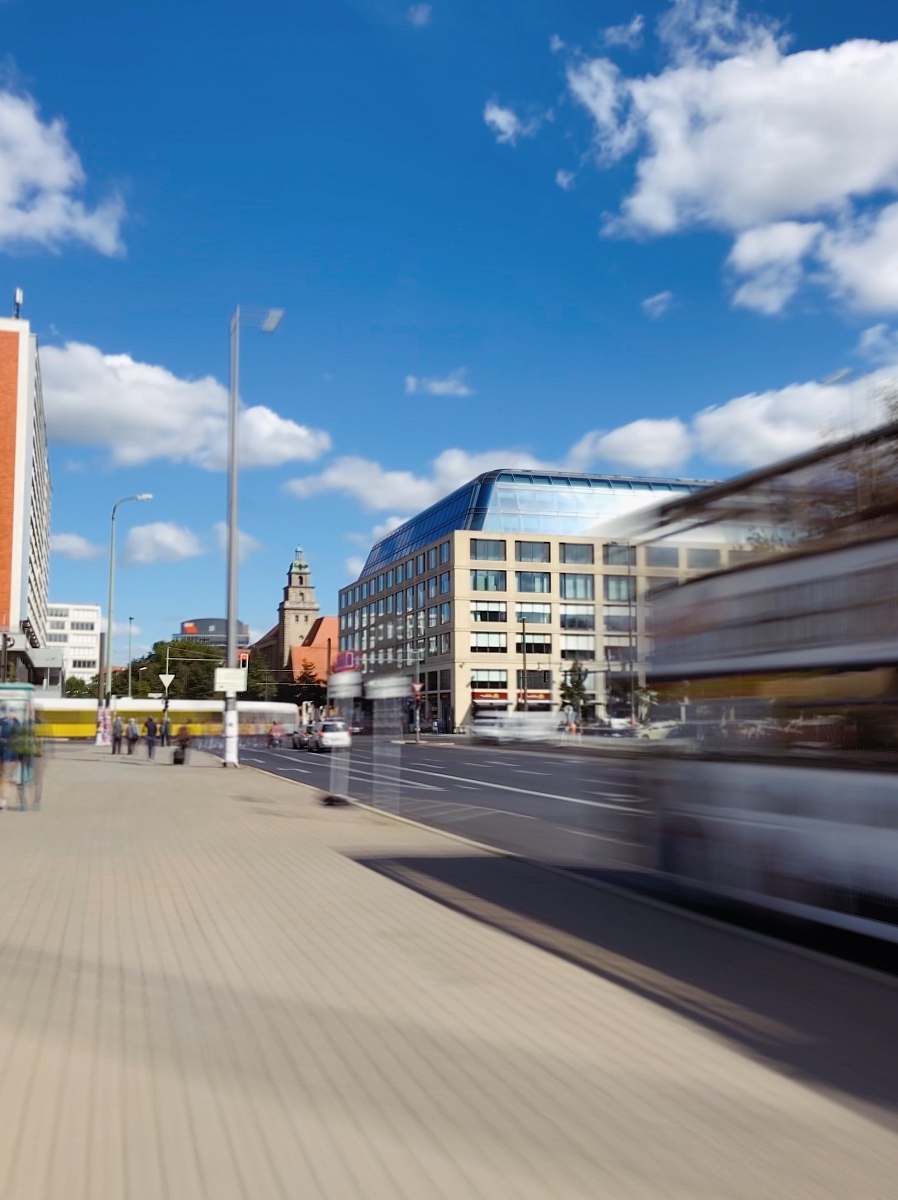 city time-lapse photography of a bus passing by the street downtown