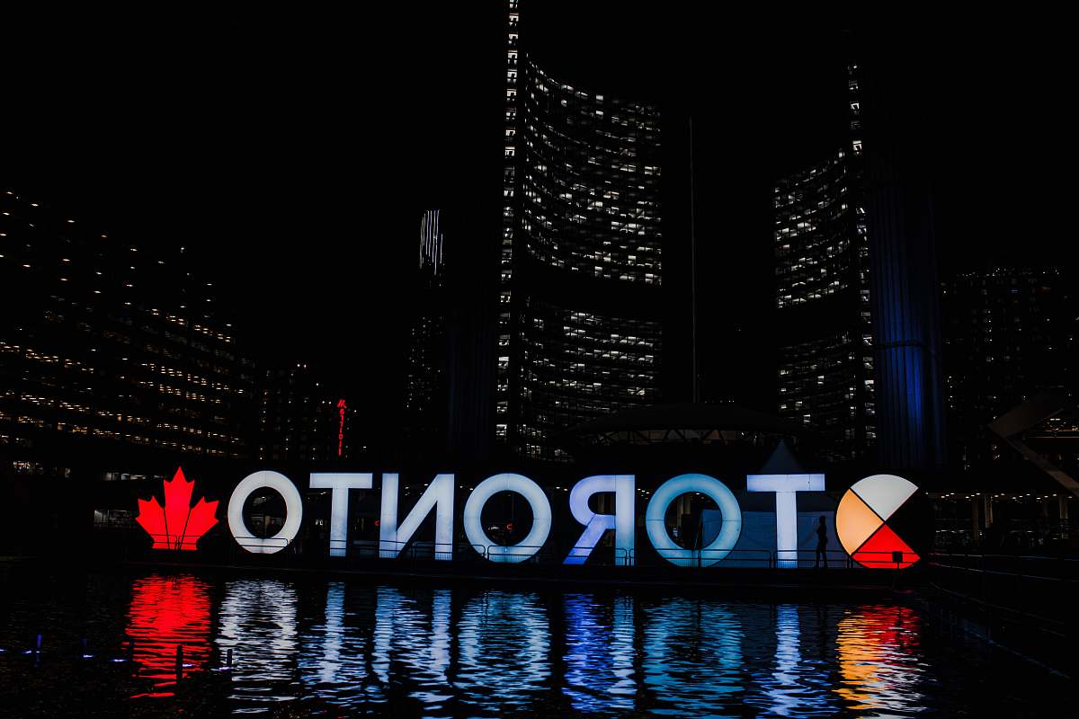 city Toronto sign reflecting on body of water at night metropolis