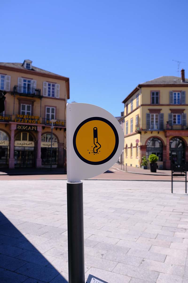 city traffic white and yellow signage downtown