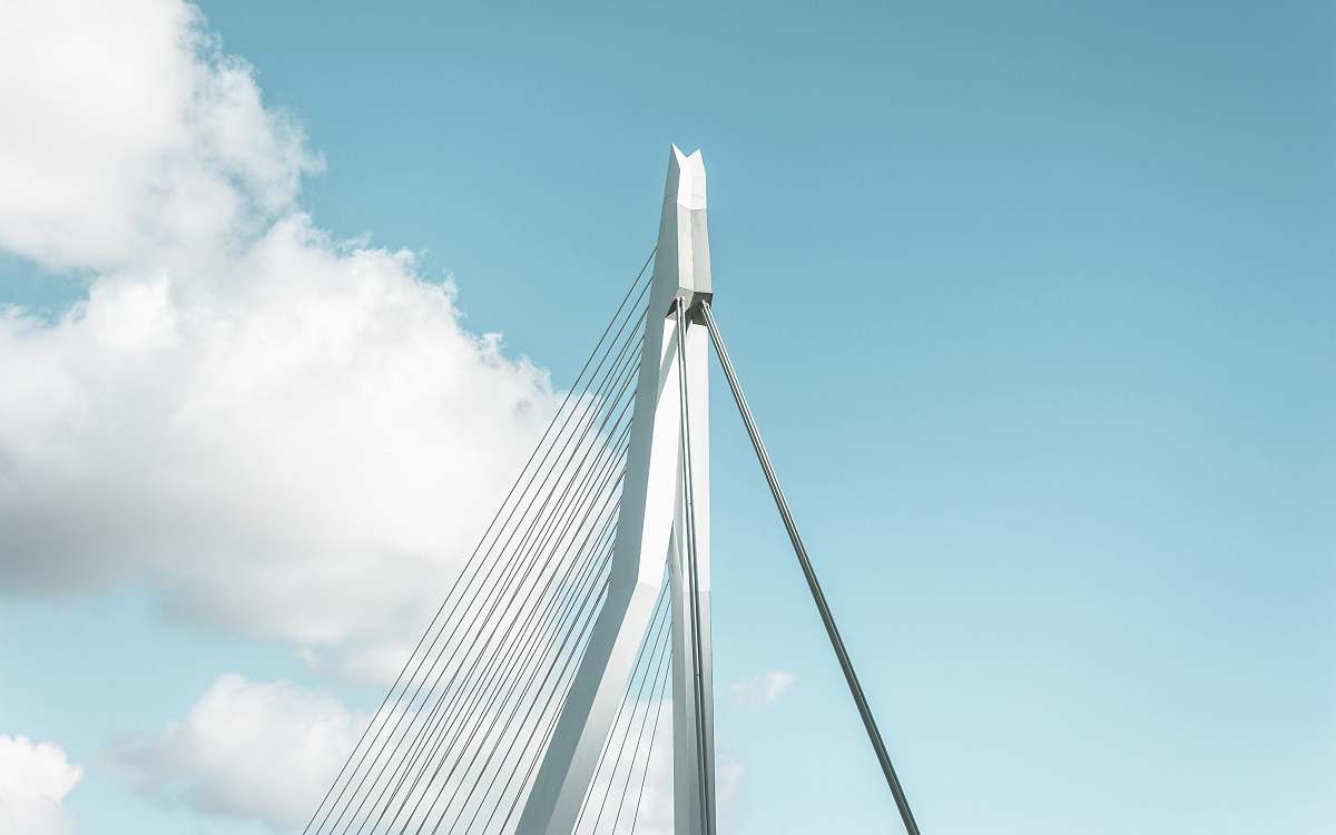 Explore the elegance of a stunning white bridge, crowned with a tall tower, gracefully spanning over a tranquil natural landscape. This picturesque scene captures the harmony between architectural beauty and the serene surroundings, making it a perfect backdrop for travel blogs, nature conservation projects, or as an inspirational image for design portfolios. Ideal for promoting outdoor adventures, scenic travel guides, or peaceful retreats, this captivating view invites viewers to appreciate the wonders of nature and human craftsmanship.