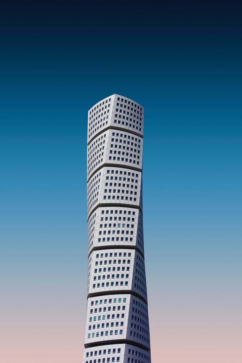 urban white high-rise building under a blue sky town