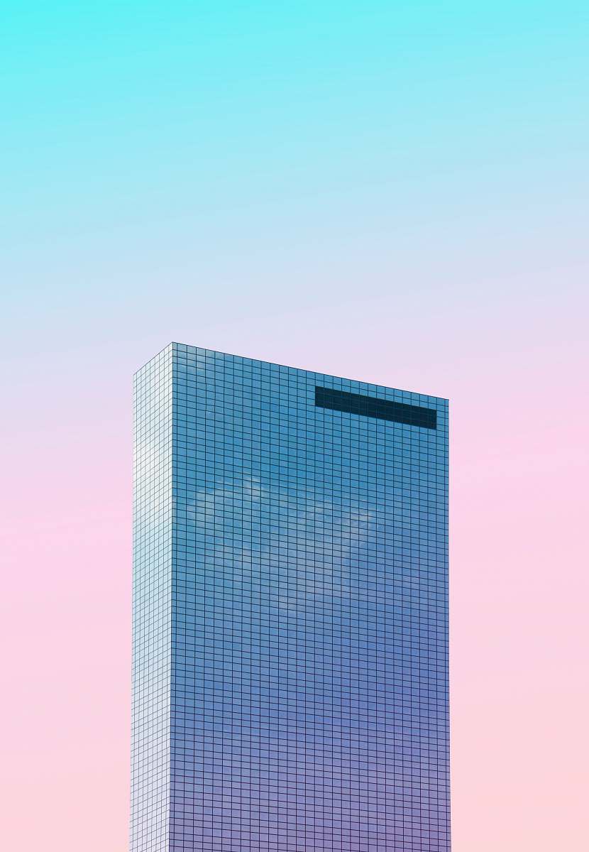 Experience a captivating worm's eye view of a towering skyscraper set against a vibrant pink sky. This striking image captures the essence of modern architecture, showcasing the impressive height and design of the building. Ideal for use in urban development projects, architectural presentations, or as a stunning backdrop for marketing materials, this photograph evokes a sense of aspiration and creativity.