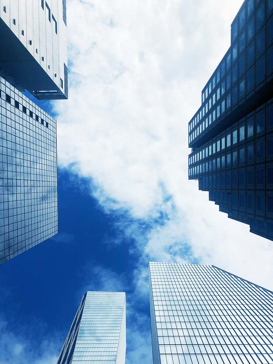 city worm's eye view photography of building under blue sky during daytime architecture