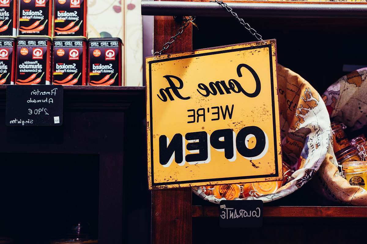 sign yellow and black come in we're open sign yellow