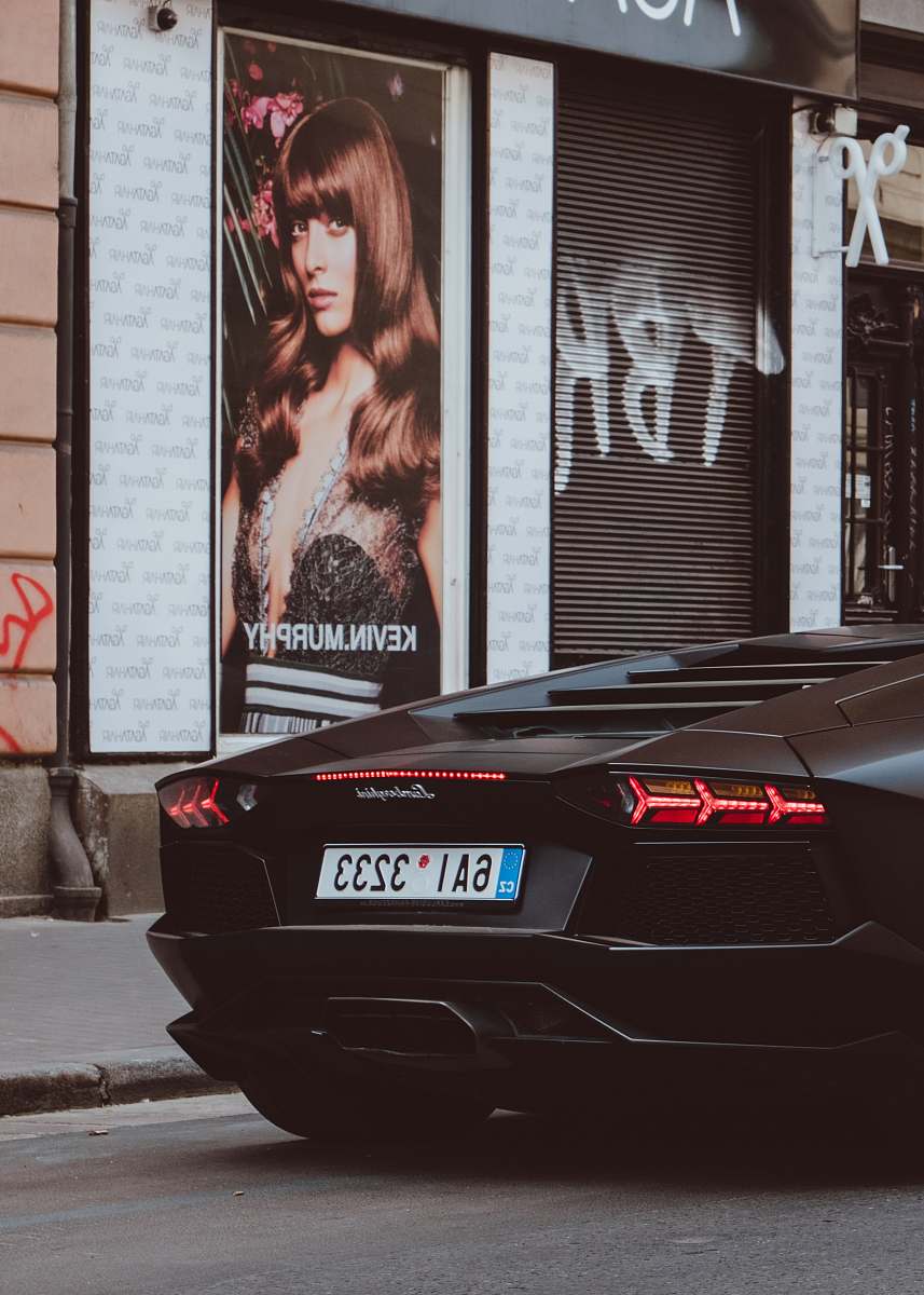human black Lamborghini beside Kevin Murphy poster person