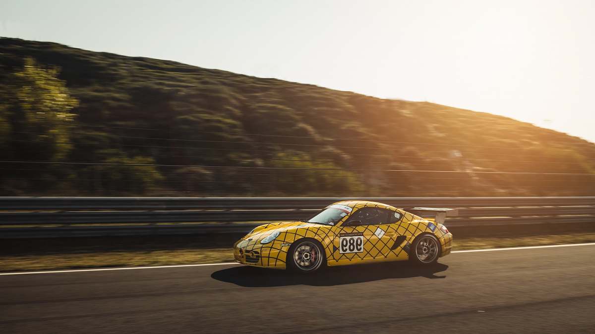automobile panning photo of yellow car running on road transportation