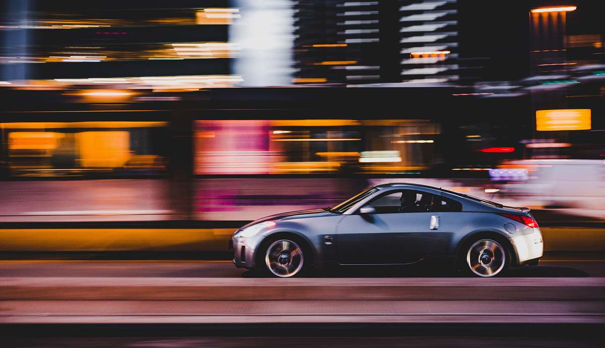 speed panning photography of gray coupe on road rotterdam