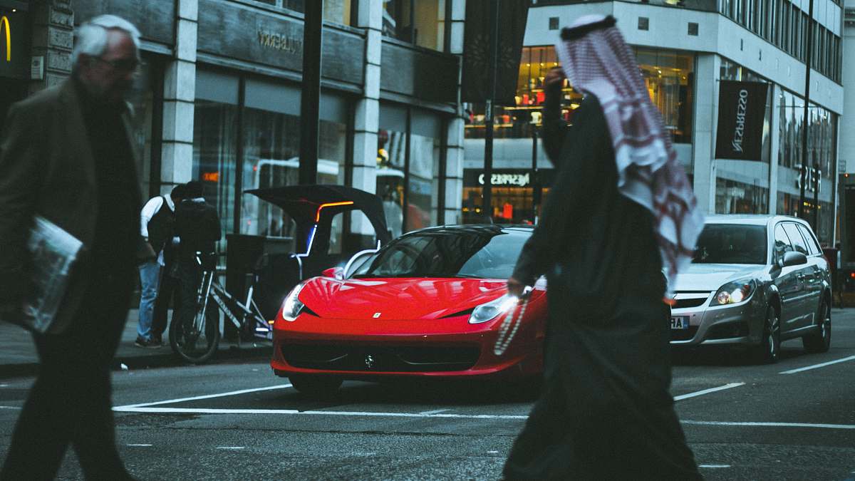 human red sports car in street people