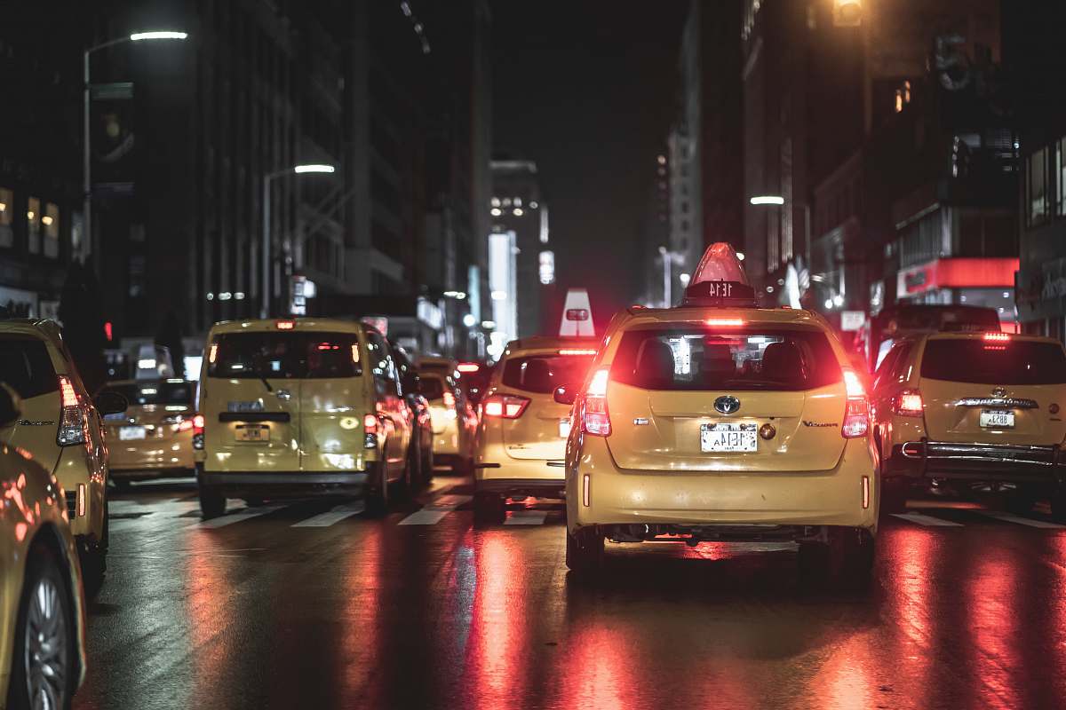 automobile vehicles on road beside buildings during nighttime transportation