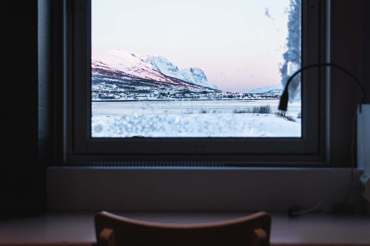 furniture closed white wooden window overlooking snow-covered mountains electronics