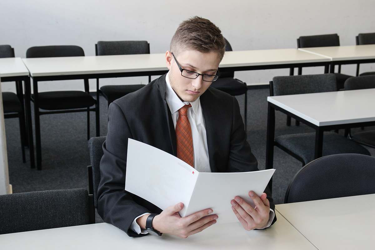 furniture man holding folder in empty room tie