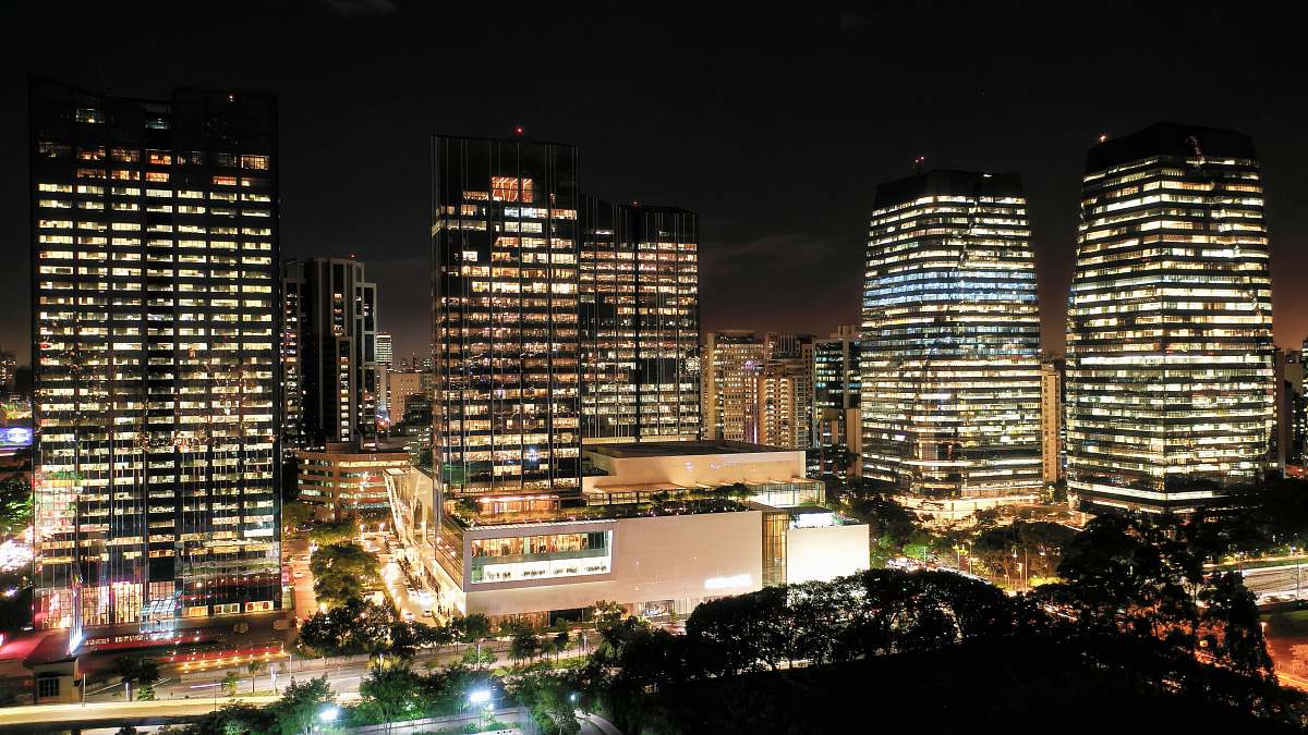 building black concrete city buildings during night time town