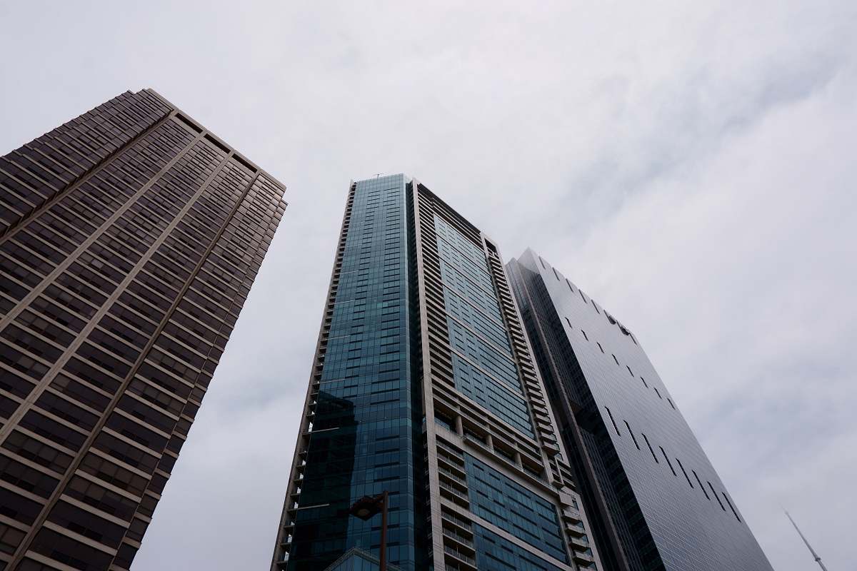building close-up photography of three high-rise buildings during daytime office building