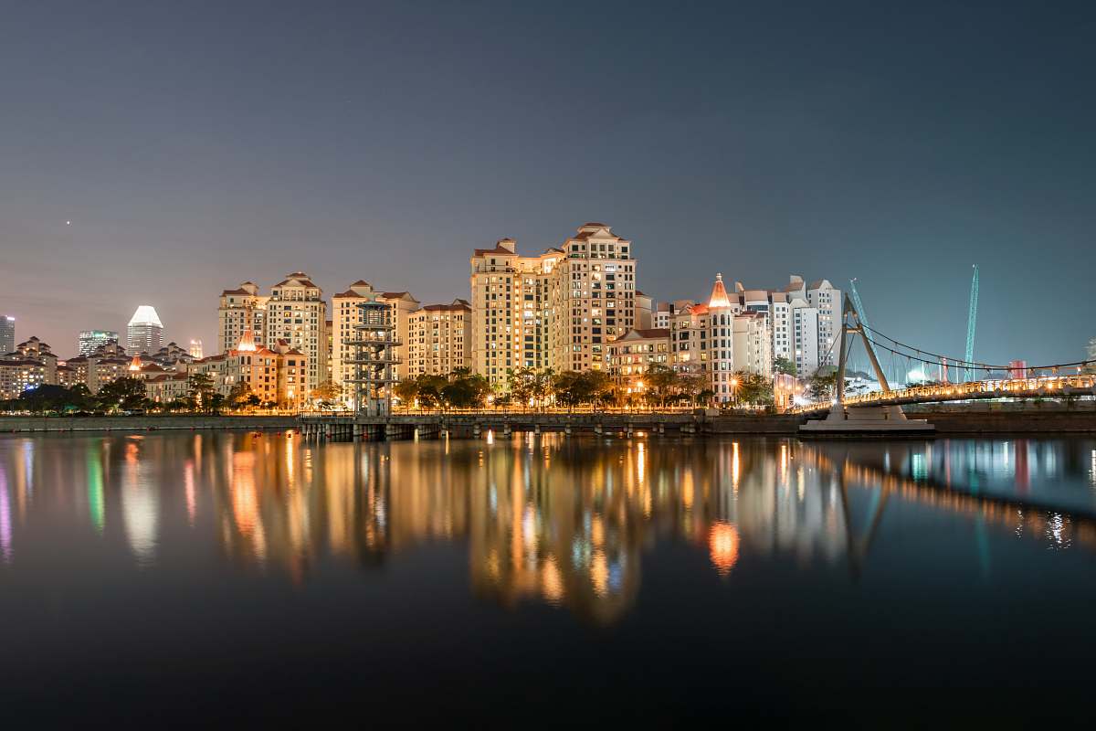 building high-rise building near calm body of water town