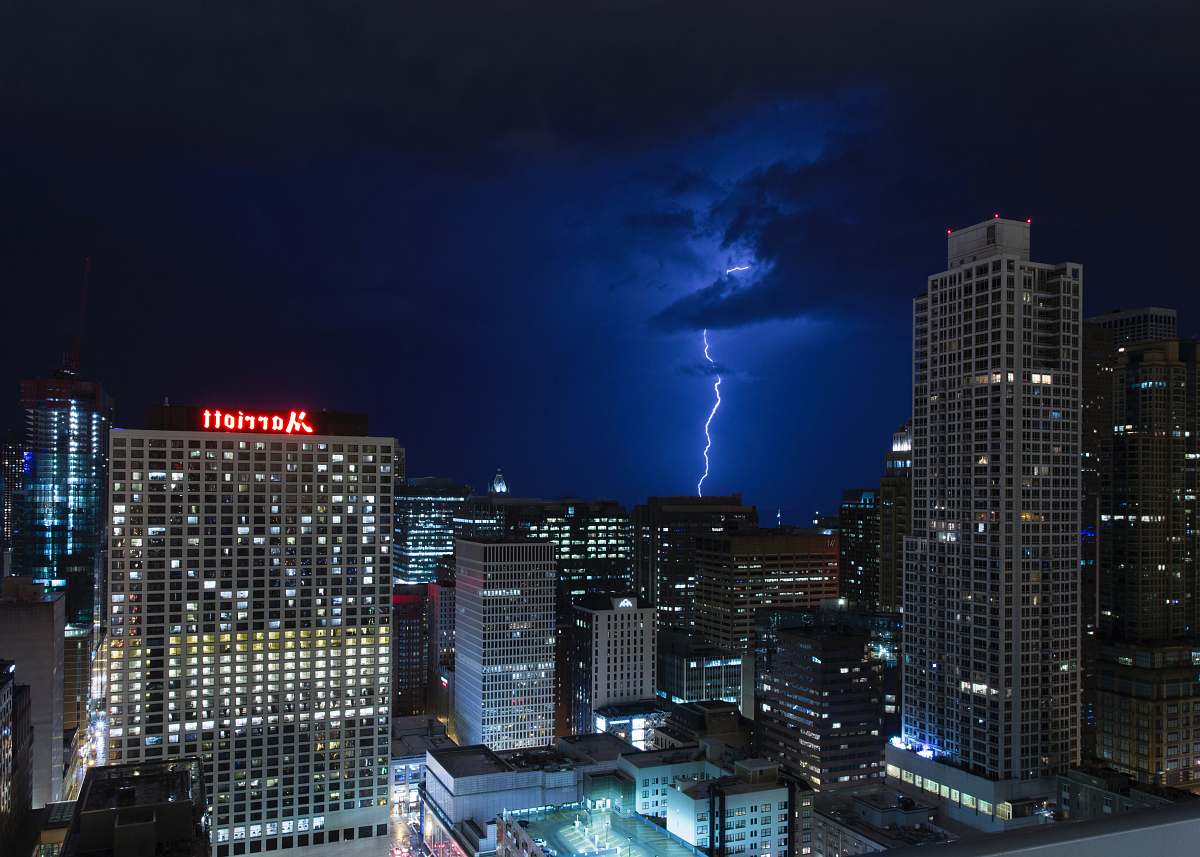 building lightning bolt near skyscrapers urban