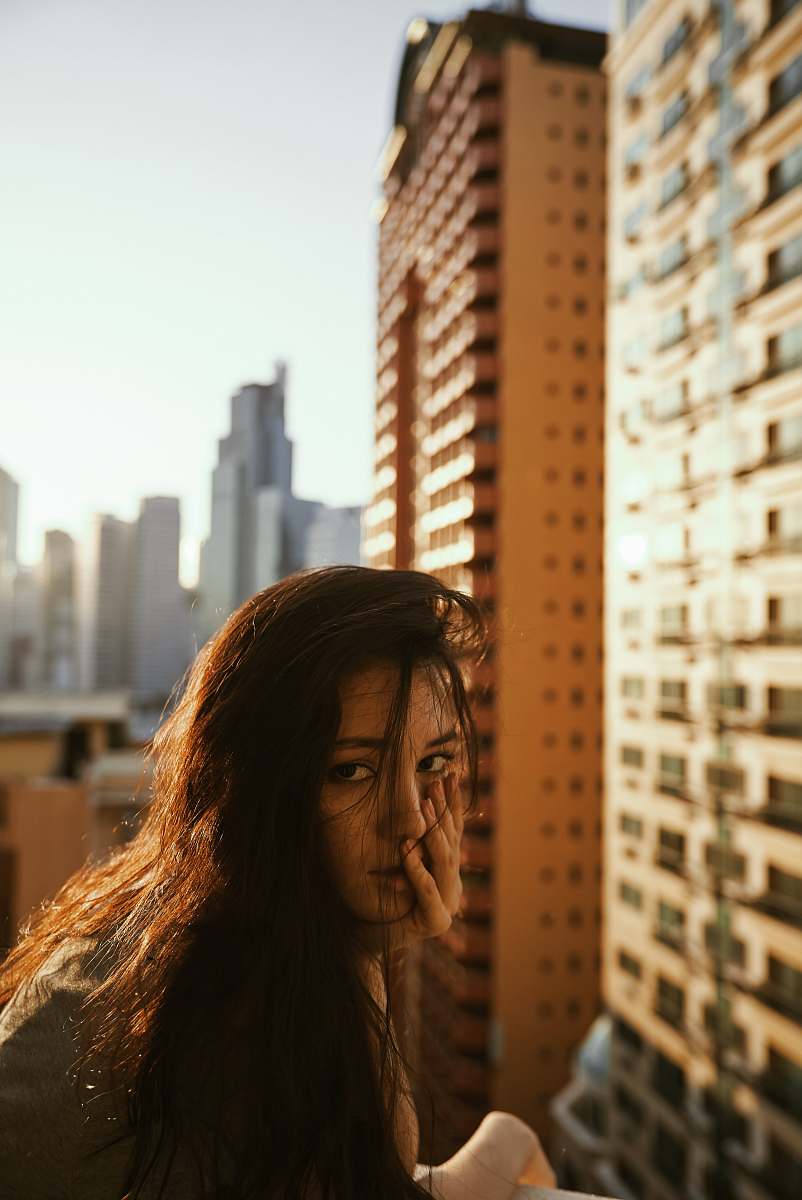 building woman in gray top beside building urban