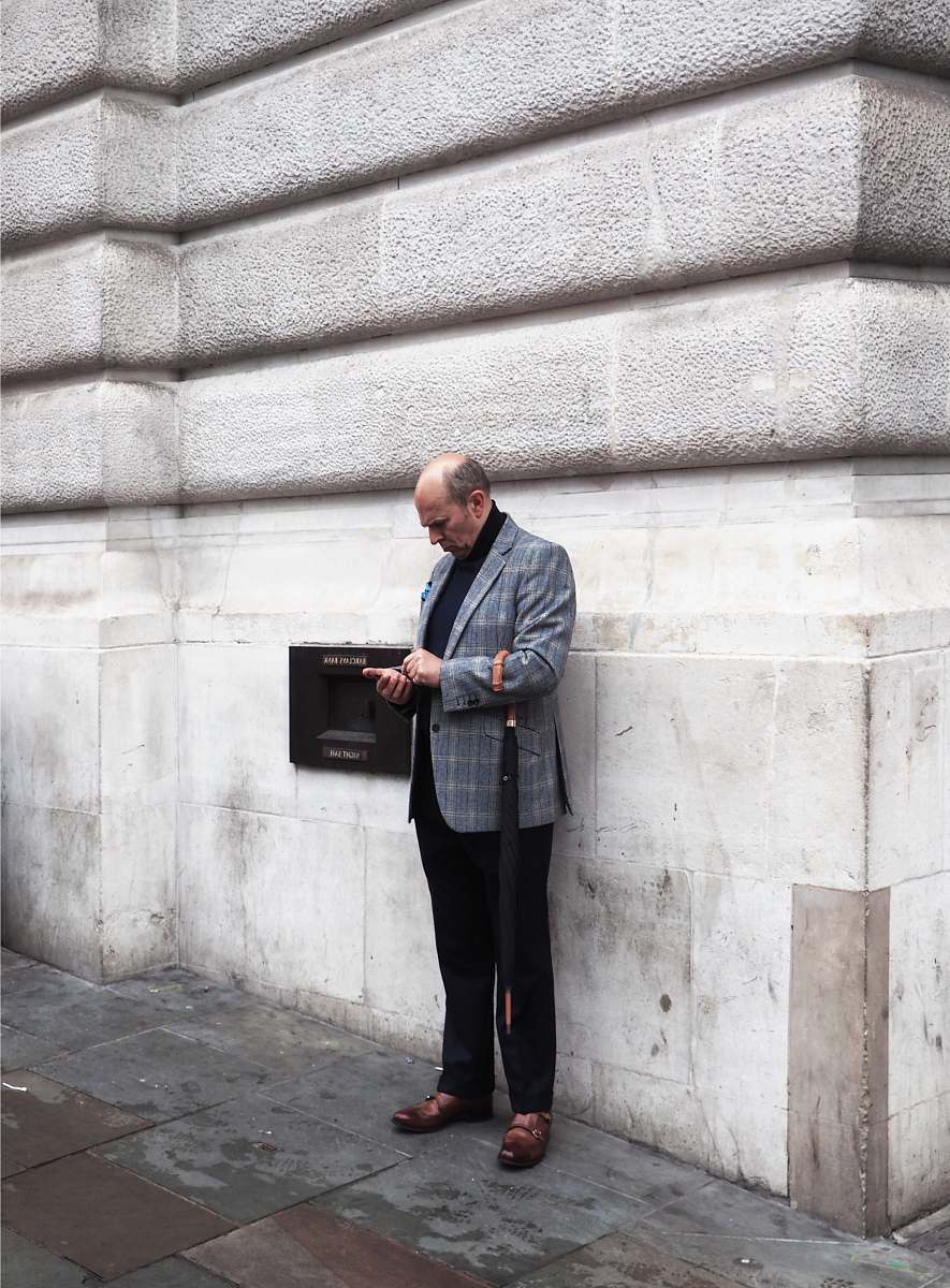 apparel man near white wall footwear