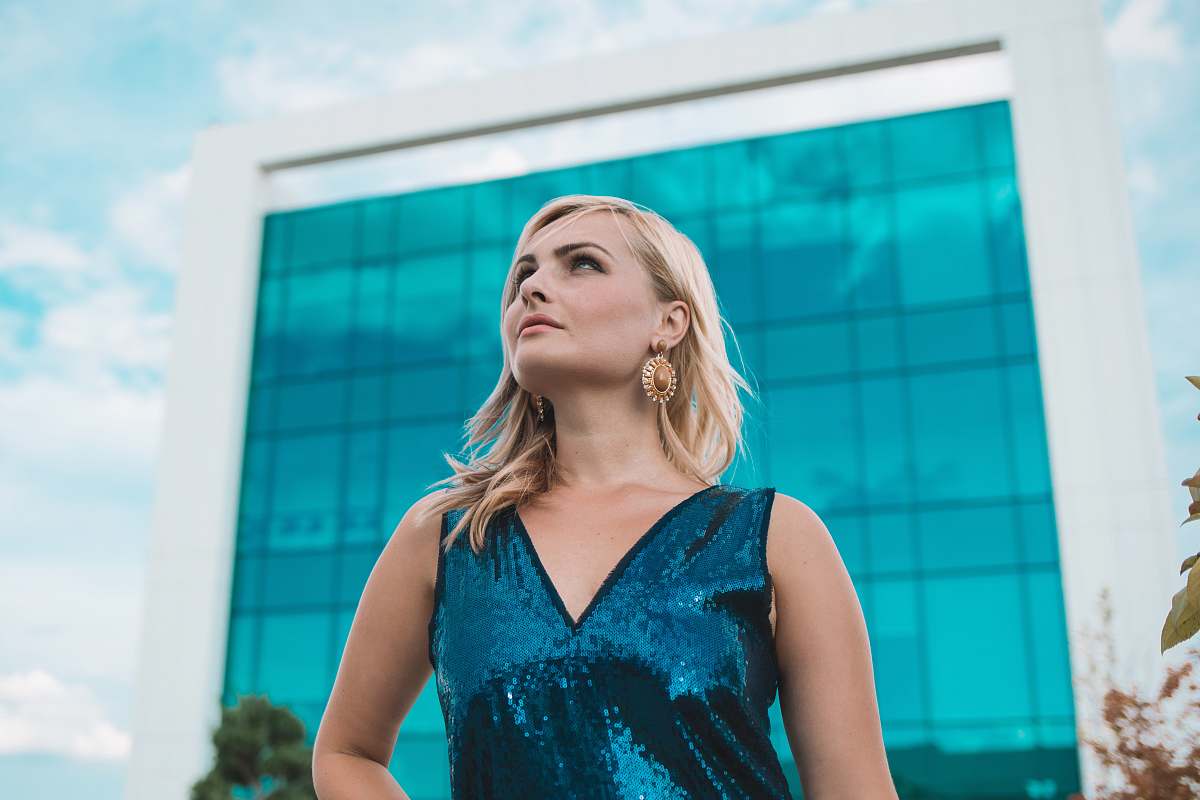 apparel woman wearing blue sleeveless top evening dress