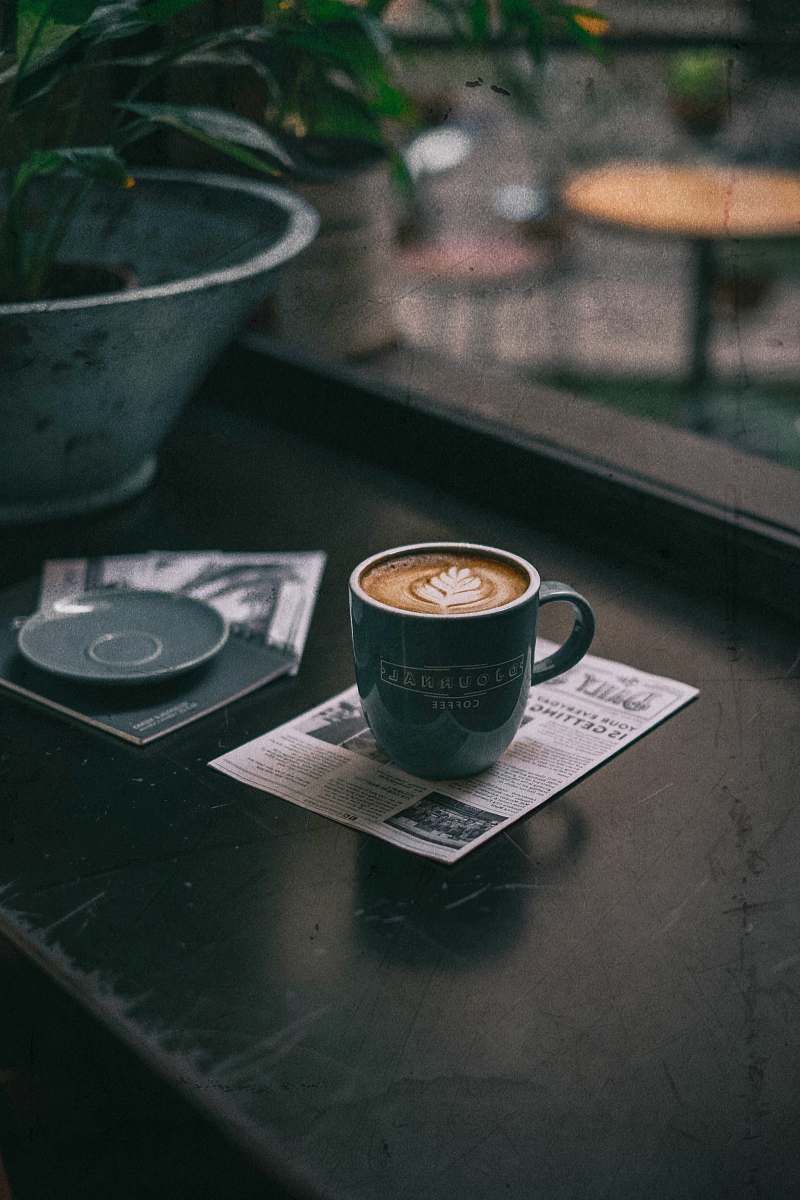 cup green cup with coffee on table djournal coffee