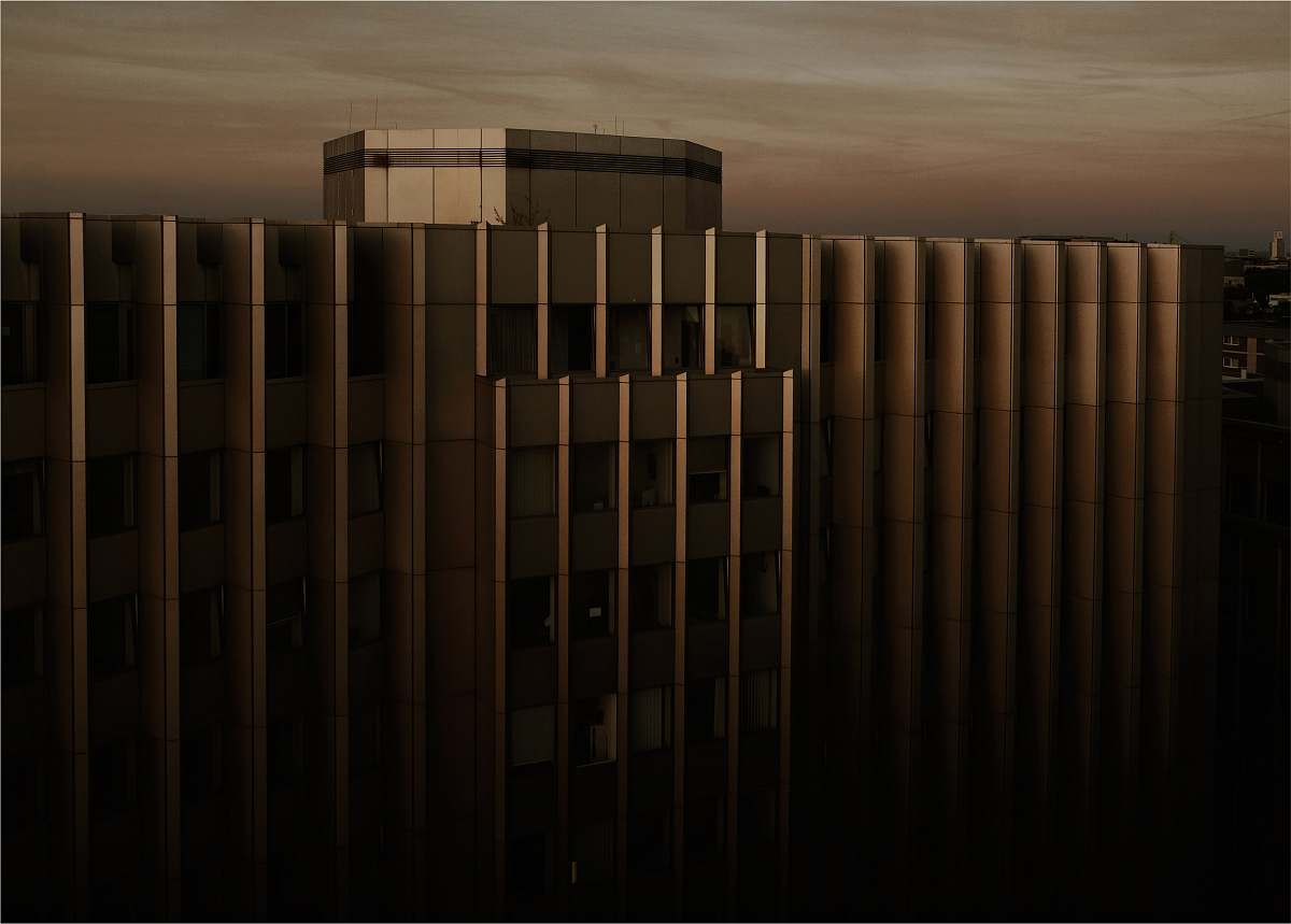 building beige concrete building under cloudy sky during sunset architecture