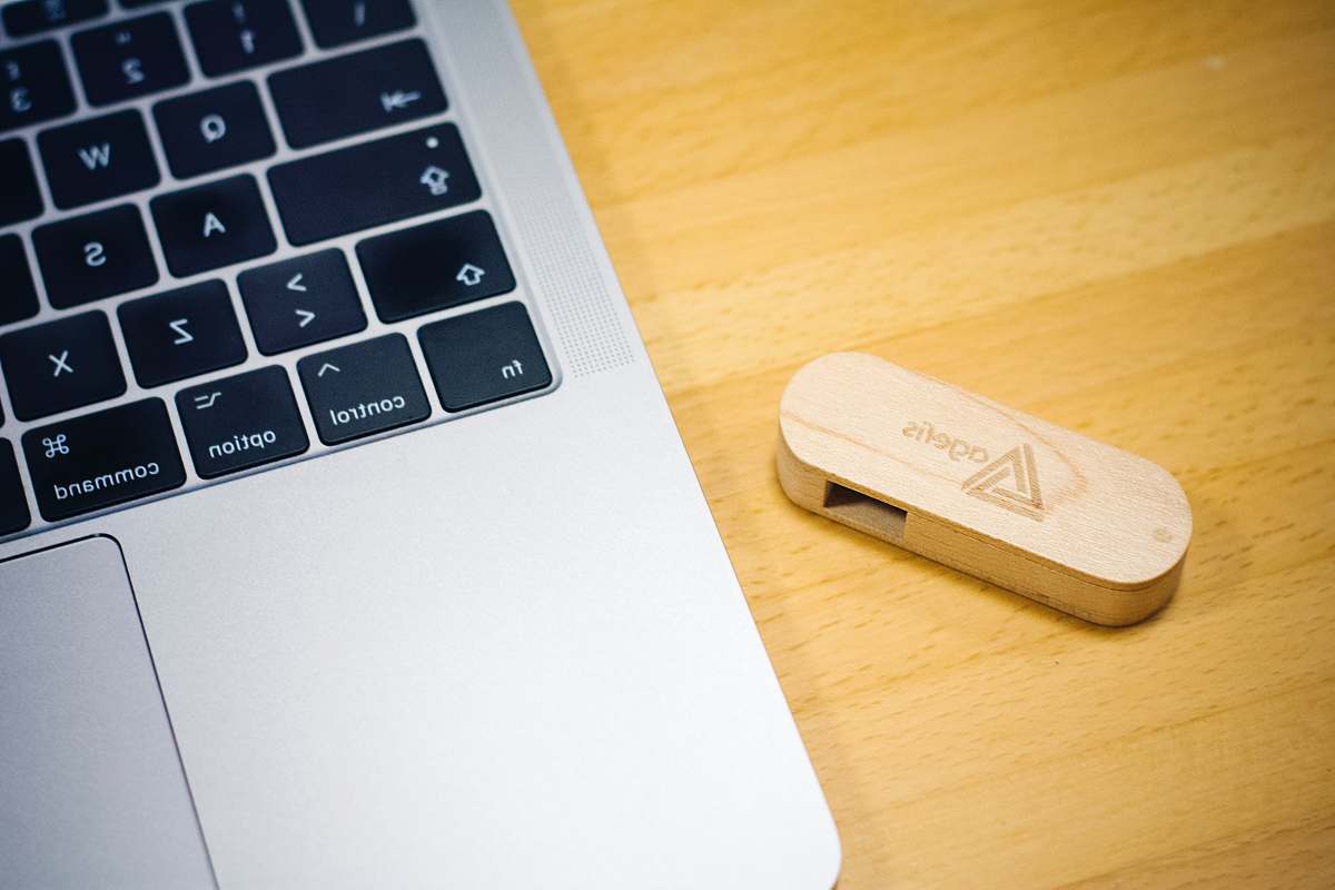 hardware brown thumb drive beside MacBook computer keyboard