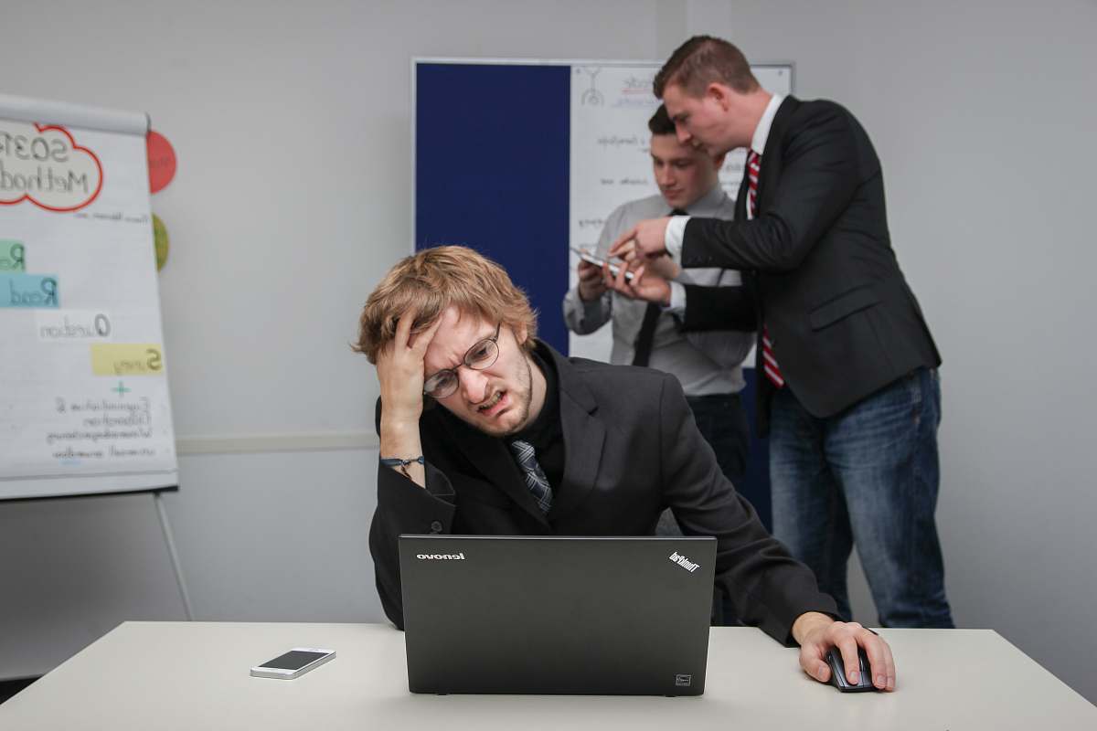 electronics man sitting on chair using gray Toshiba ThinkPad pc