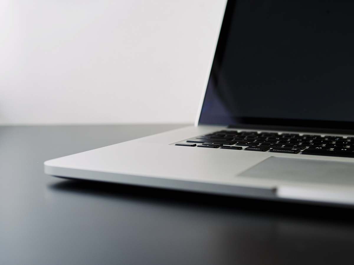 laptop silver laptop computer on black table tech