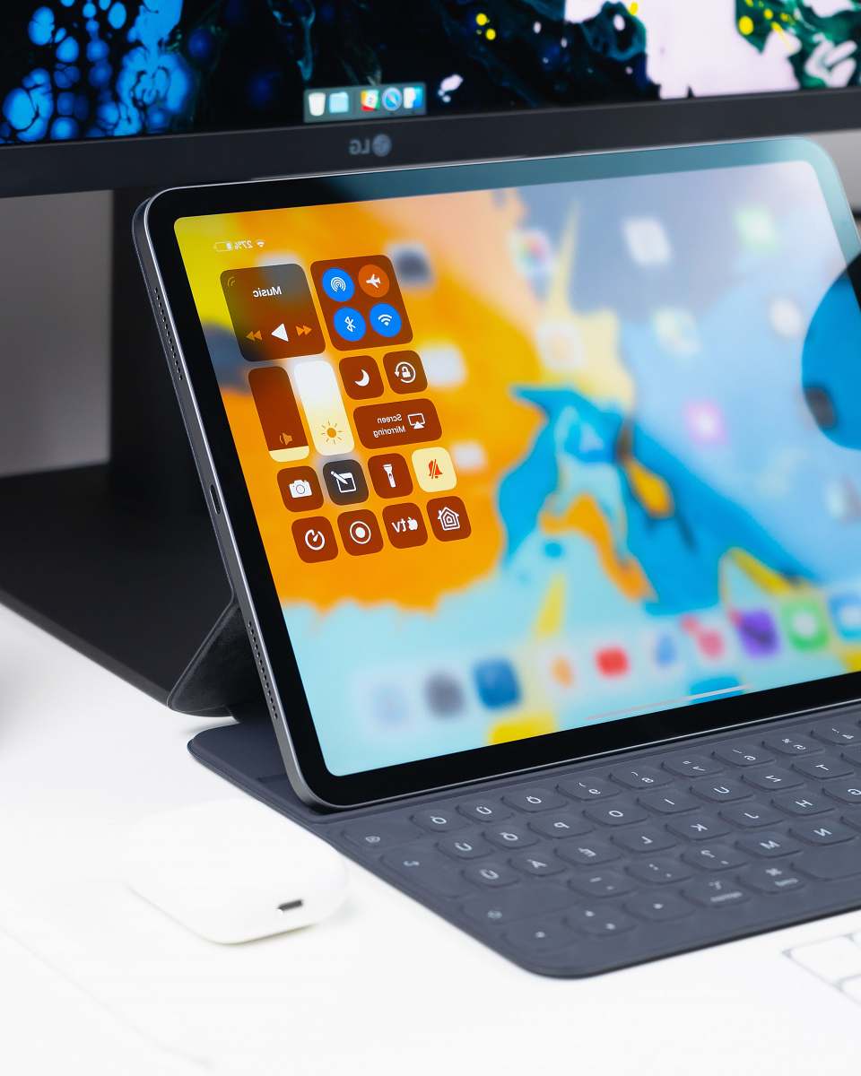 electronics turned on tablet computer on white desk tablet computer