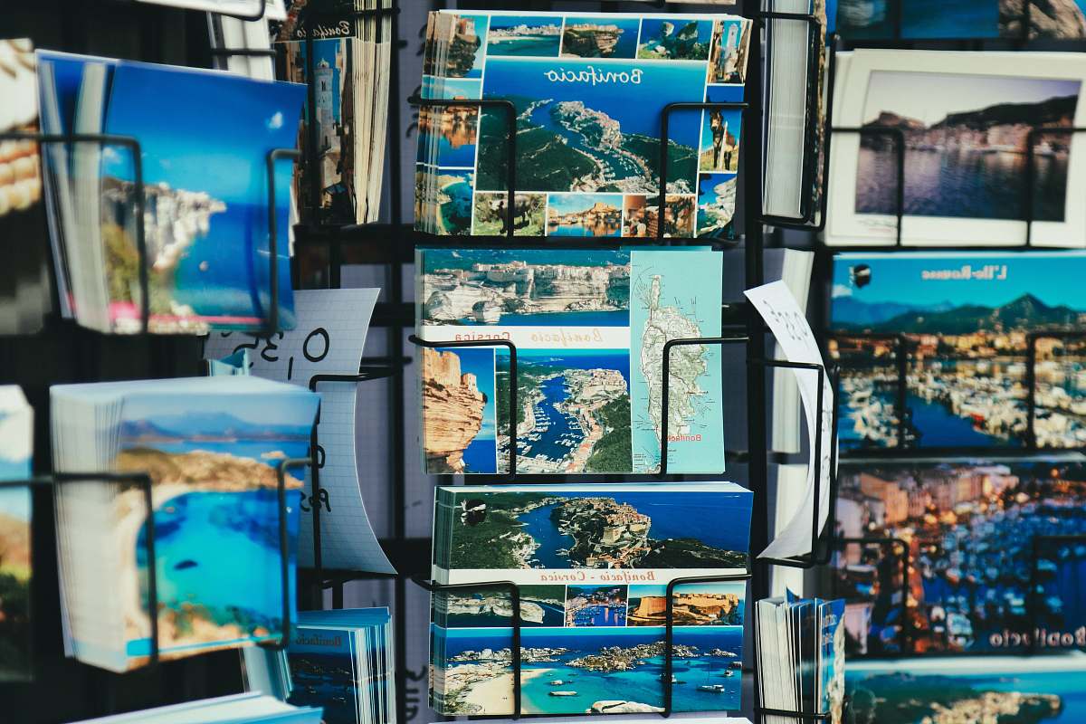 poster selective focus photography of landmarks card on rack collage