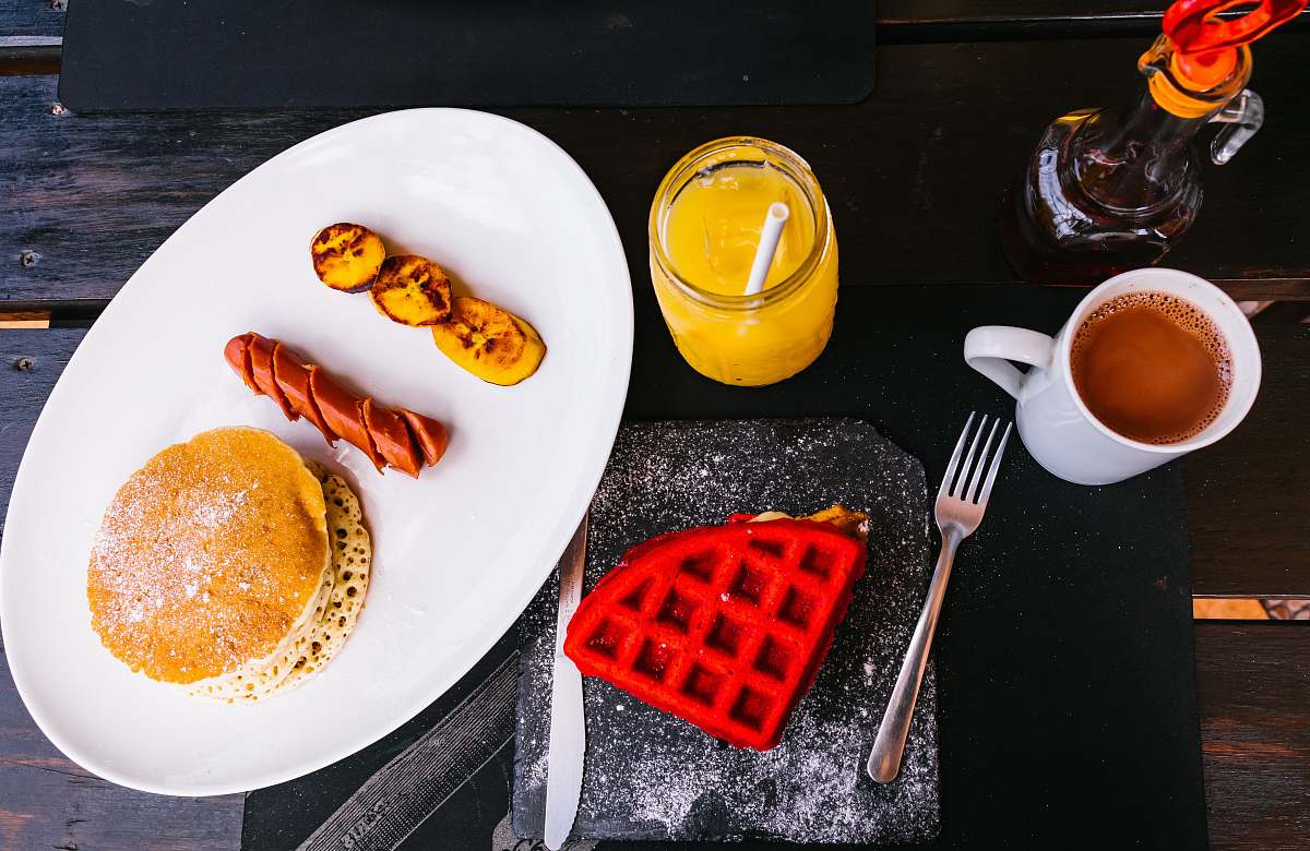 fork sausage between fried banana and pancake breakfast