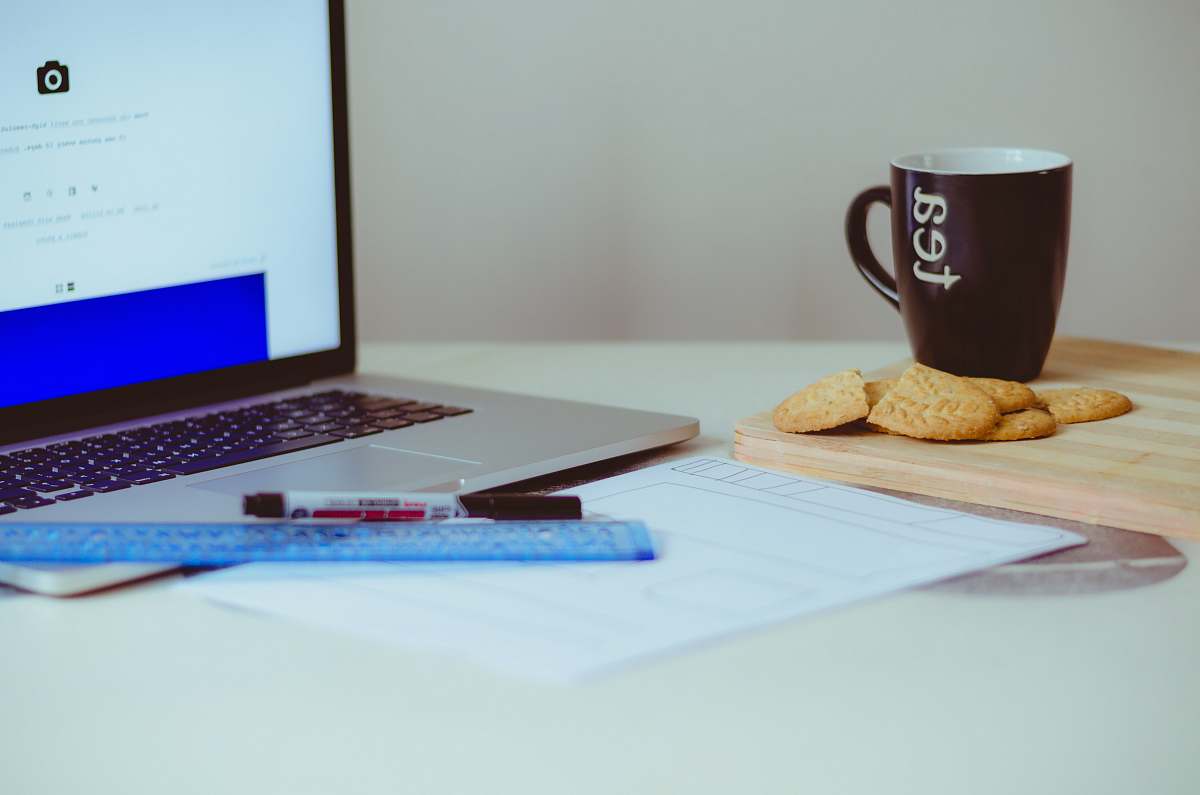 biscuit pastry beside ceramic mug cookie