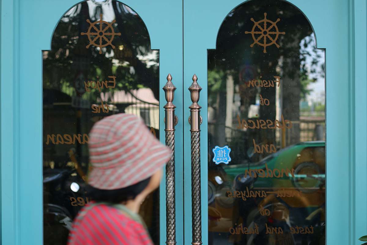 woman person standing in front of door entrance
