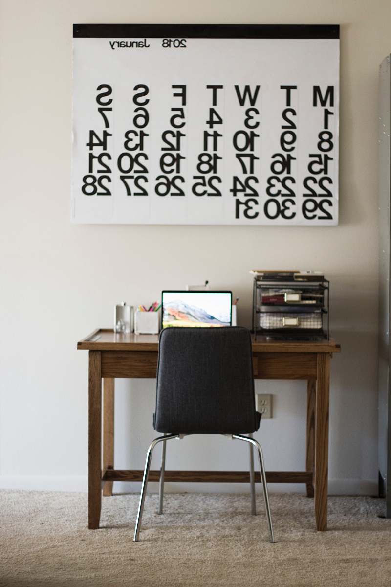 desk black chair in front of turned on laptop chair