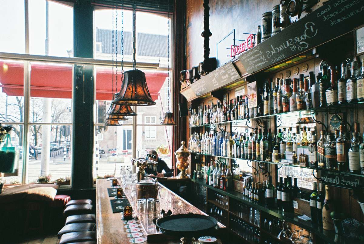 couch brown wooden bar table near window drink