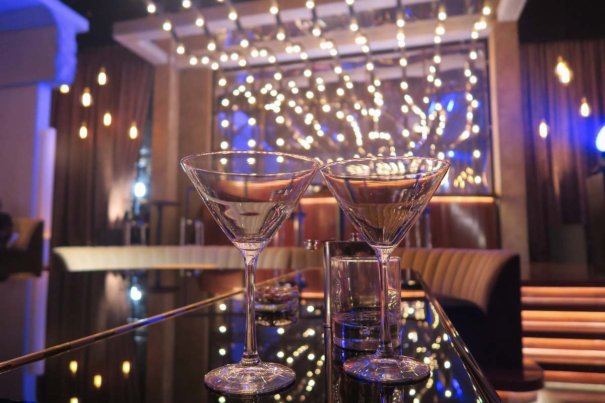 lighting two Martini glasses beverage