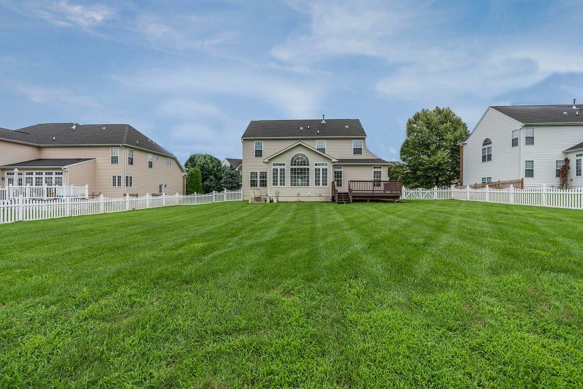 plant three 2-storey houses with fences and grass field lawn