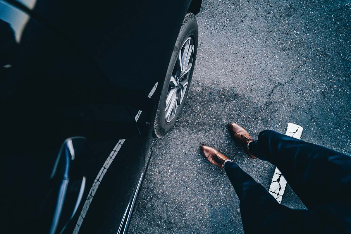 footwear person standing near car shoe