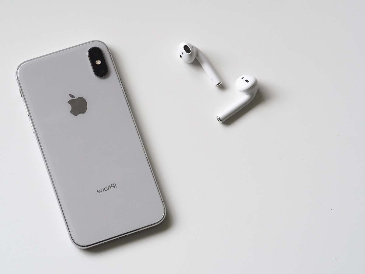 black-and-white silver iPhone X and Apple EarPods phone