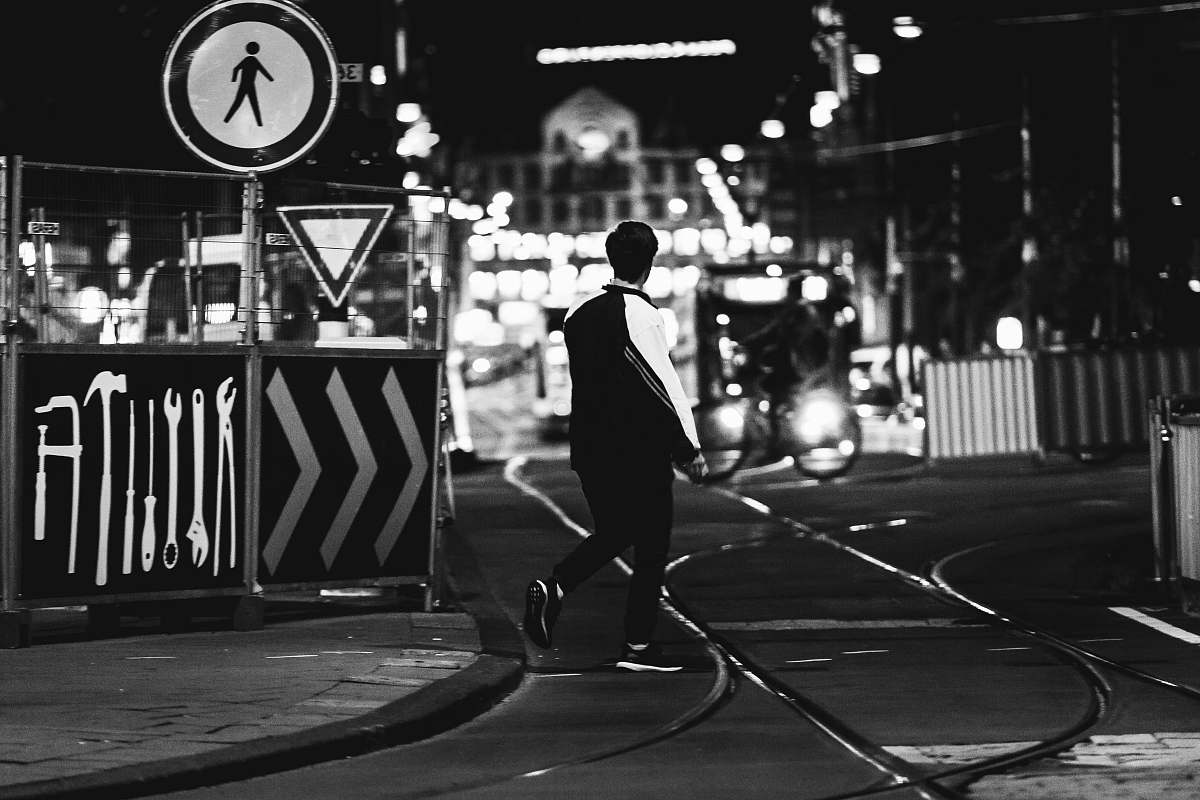 black-and-white grayscale photography of man near road person
