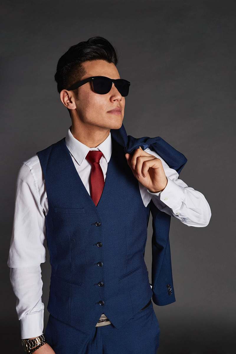 person man carrying blue jacket while looking sideways people