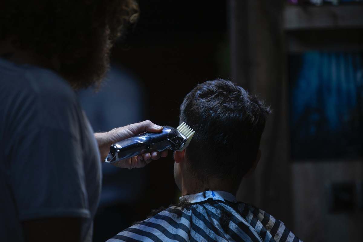 person man cutting the hair using hair clipper photography mashhad