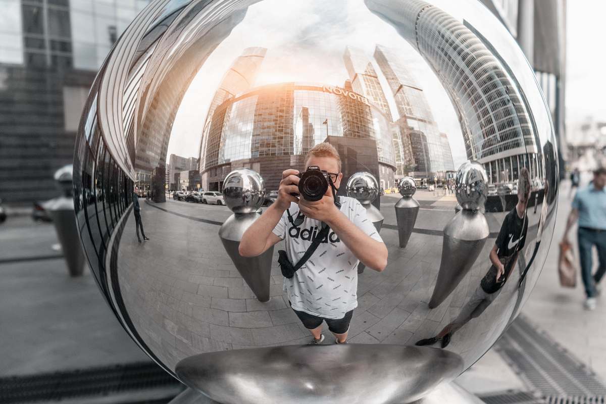 person man holding DSLR camera moscow city