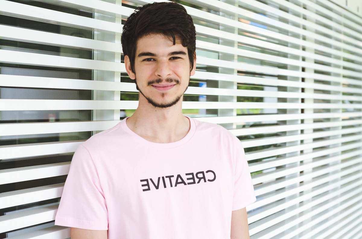 person man standing near window apparel