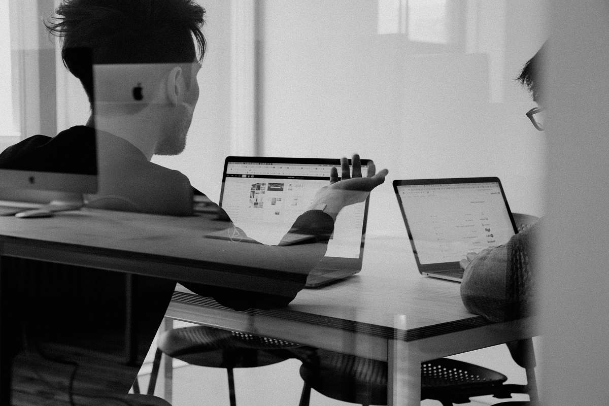 person man using MacBook black-and-white