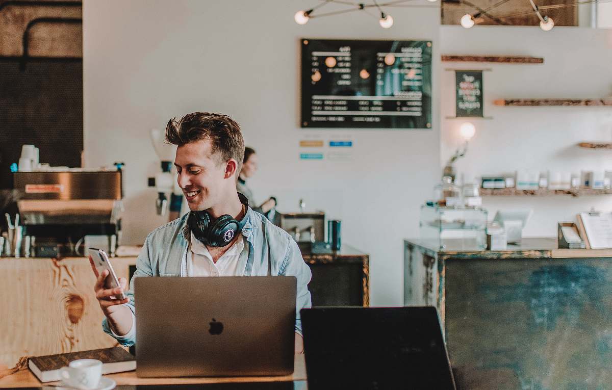 person man using smartphone smiling electronics