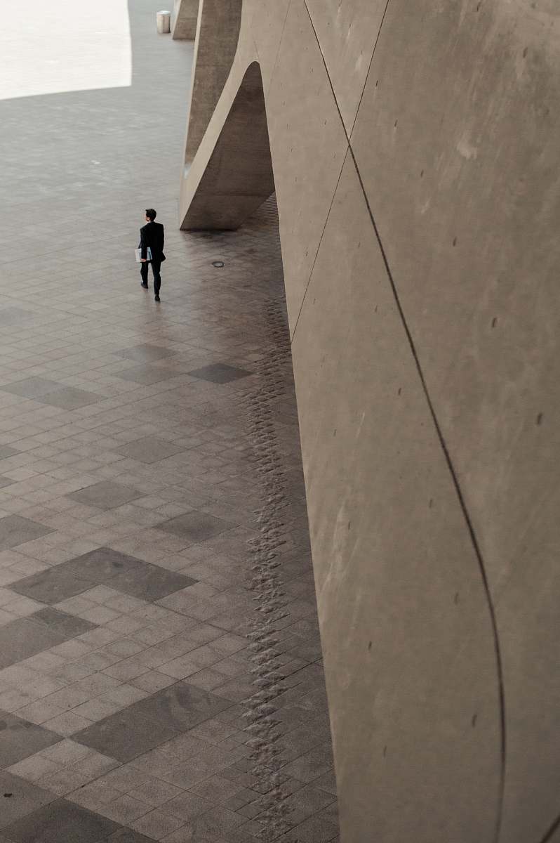 person man walking beside building floor