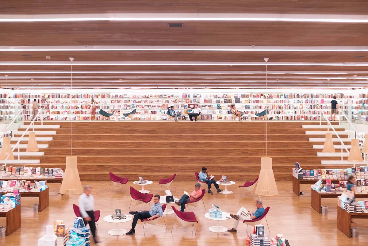 person people sitting and others are standing inside building wood